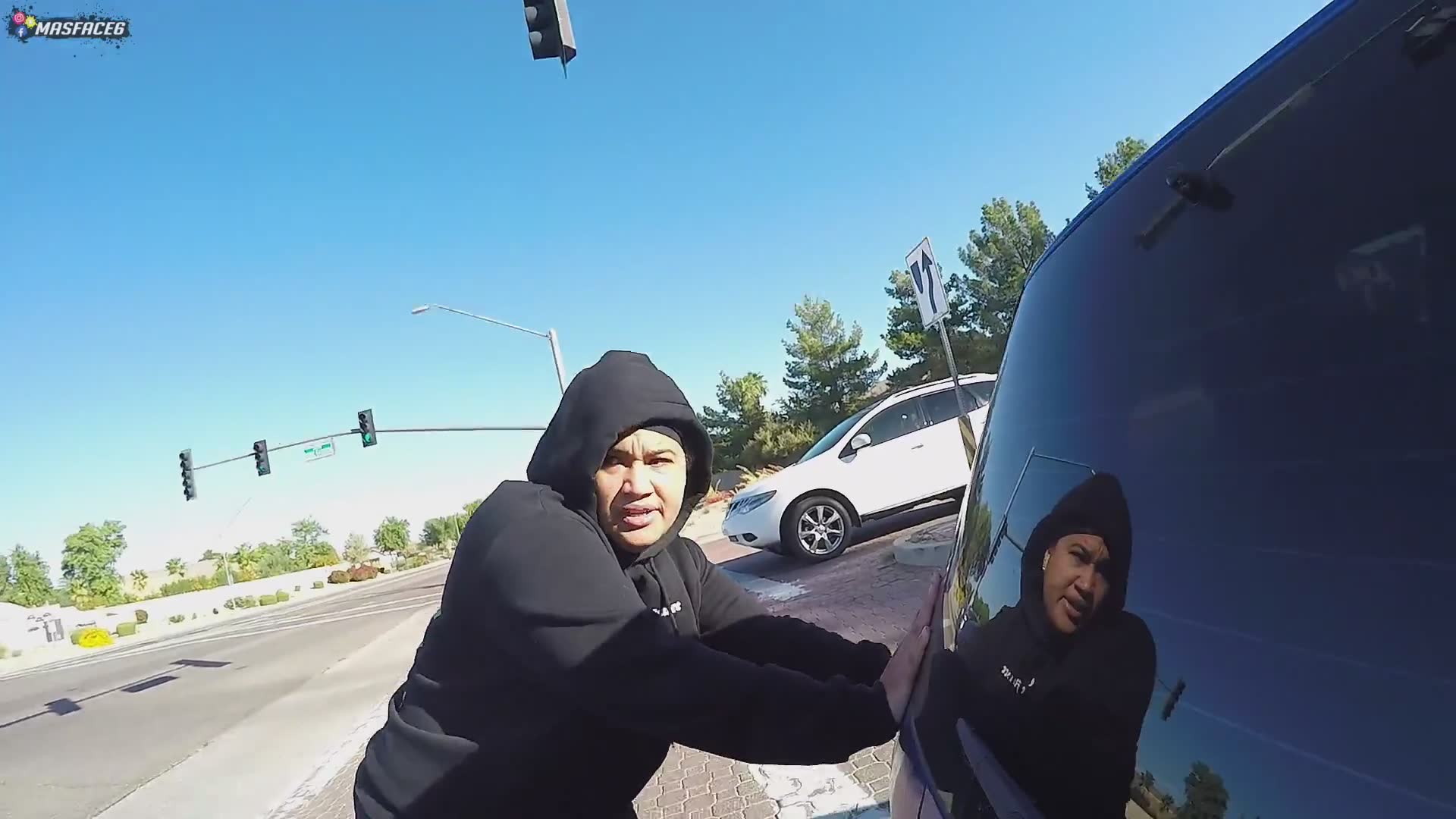 Biker pushes disabled car out of roadway
