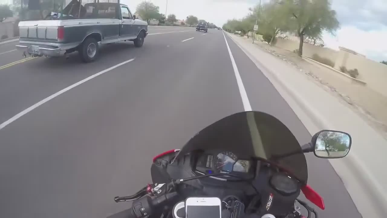 Rider promotes personal brand by distributing promotional cards during traffic stops