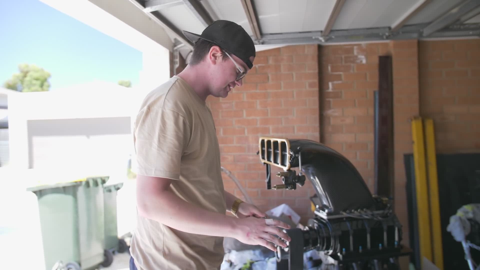 Installing the rebuilt powerplant back into the competition wagon's engine bay