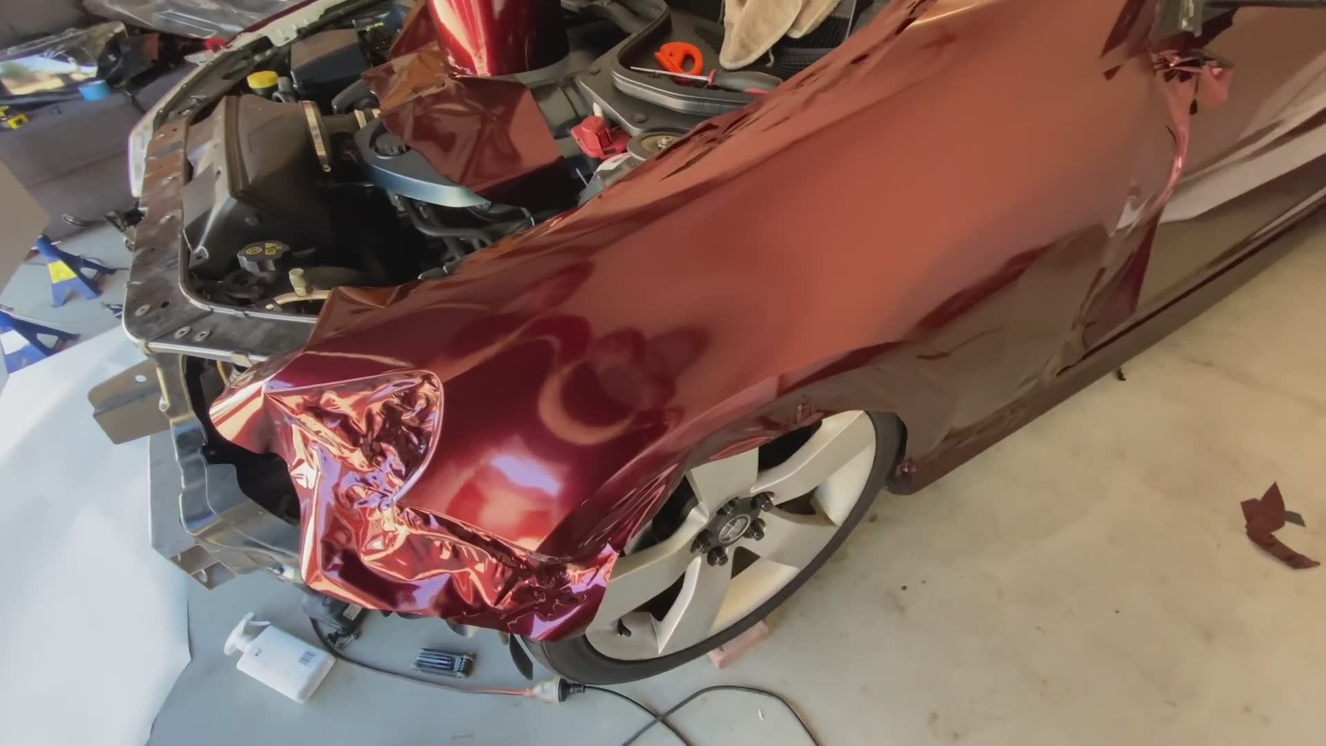 Final stages of full vehicle vinyl wrap installation with detailed technique tips