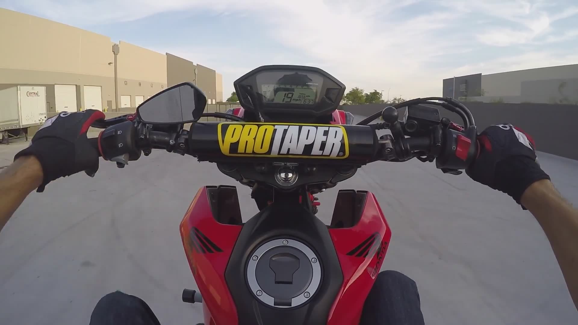 Mini bike rider demonstrates perfect balance control pulling vertical wheelies