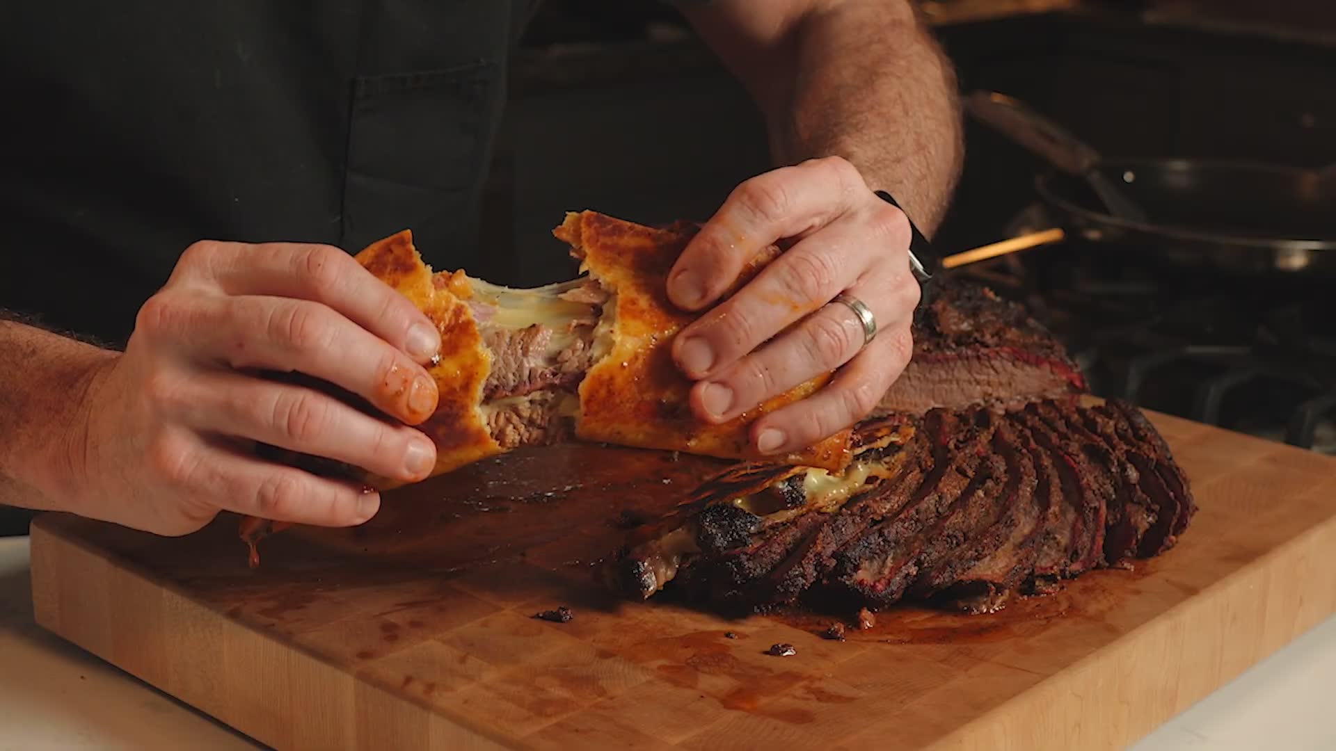 Smoked brisket birria tacos with melted cheese on a Traeger pellet grill