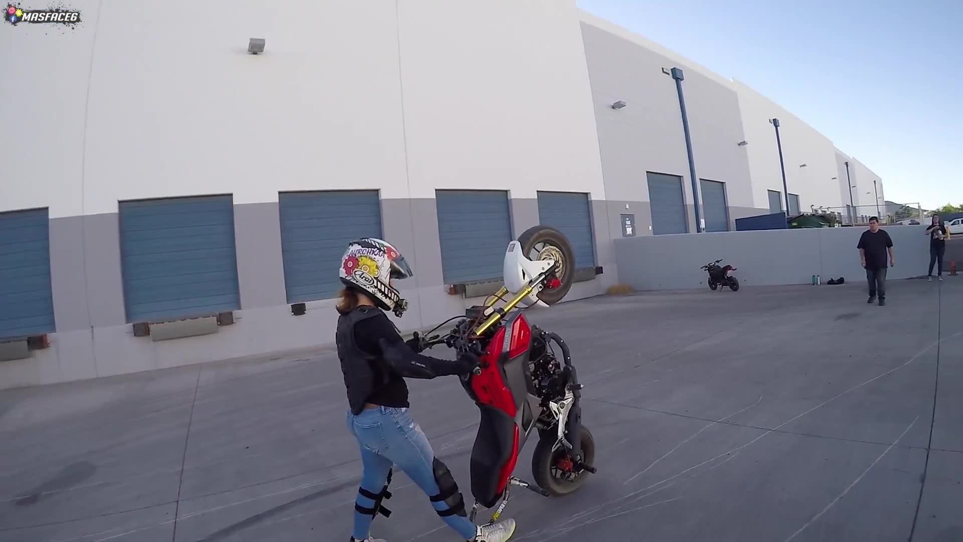 Female rider receives wheelie training and attempts lifting front wheel