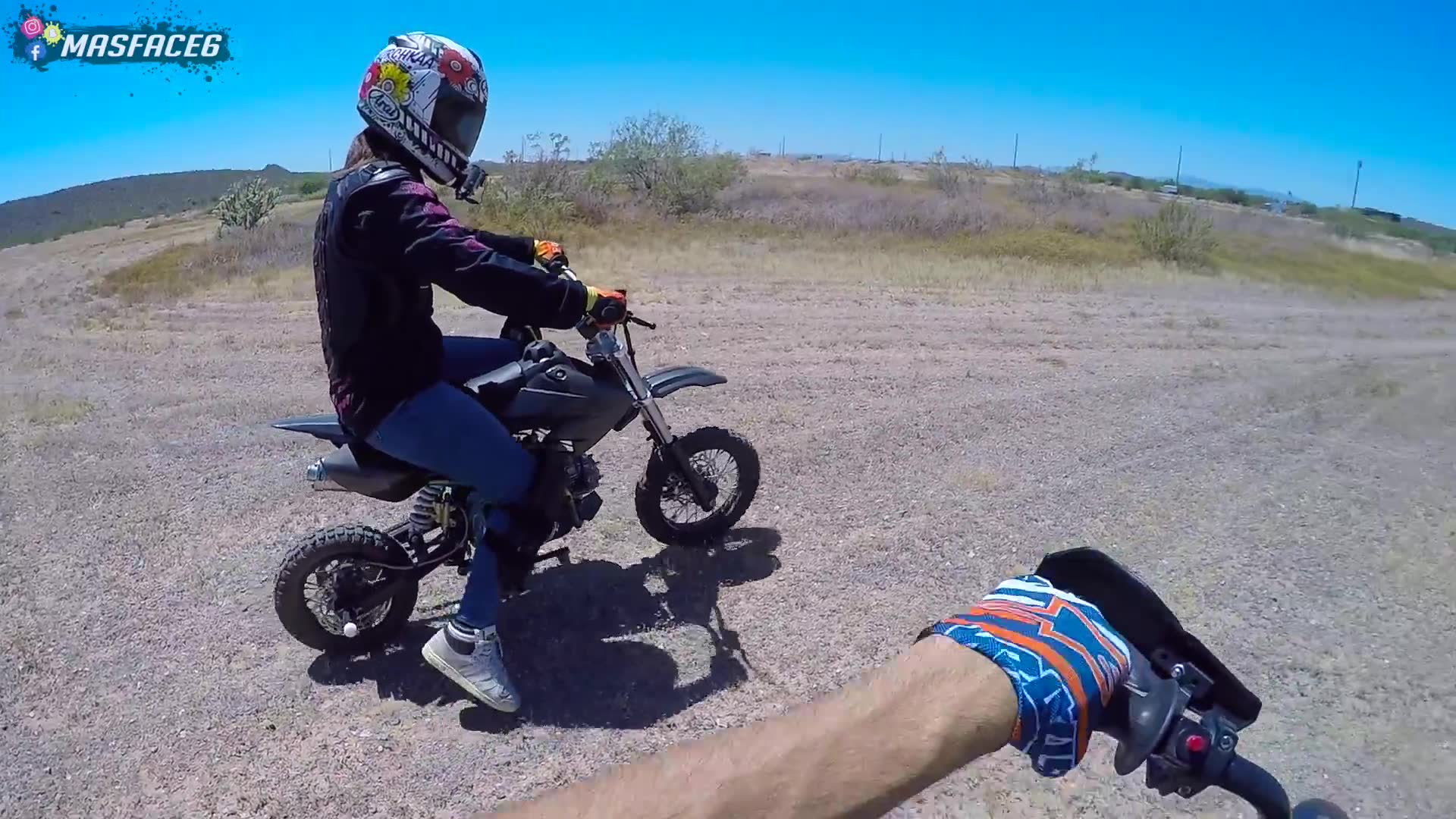 Couple rides small pit bikes together around neighborhood and parking lots