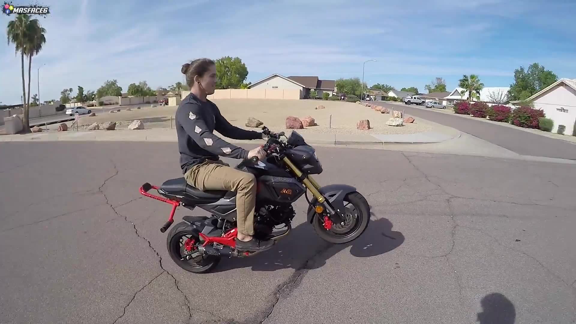 Male friend learns wheelie technique with instruction and practice