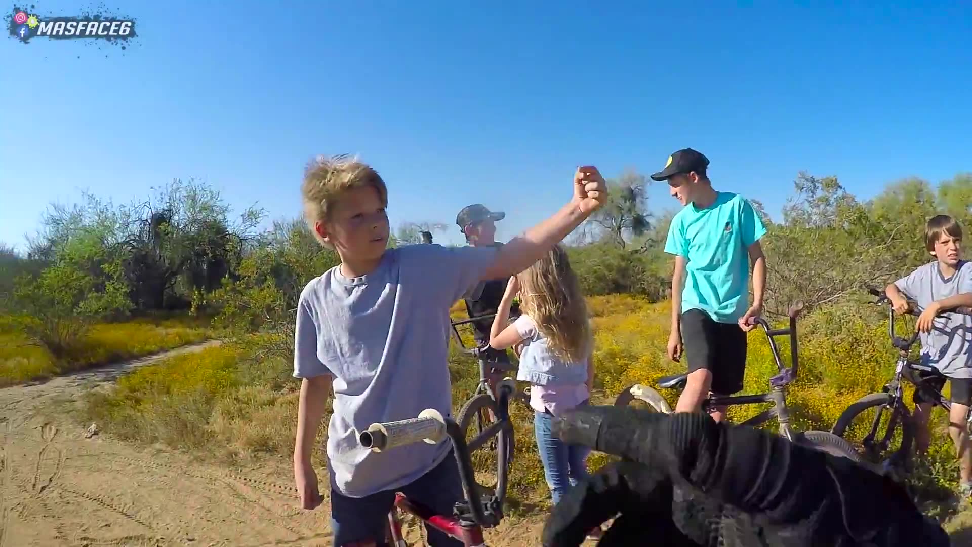 Young kid on bicycle attempts to challenge and race motorcyclist