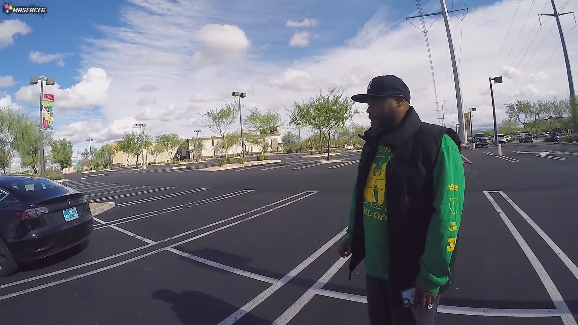 Random stranger shows off the self-driving features of his electric car to a biker