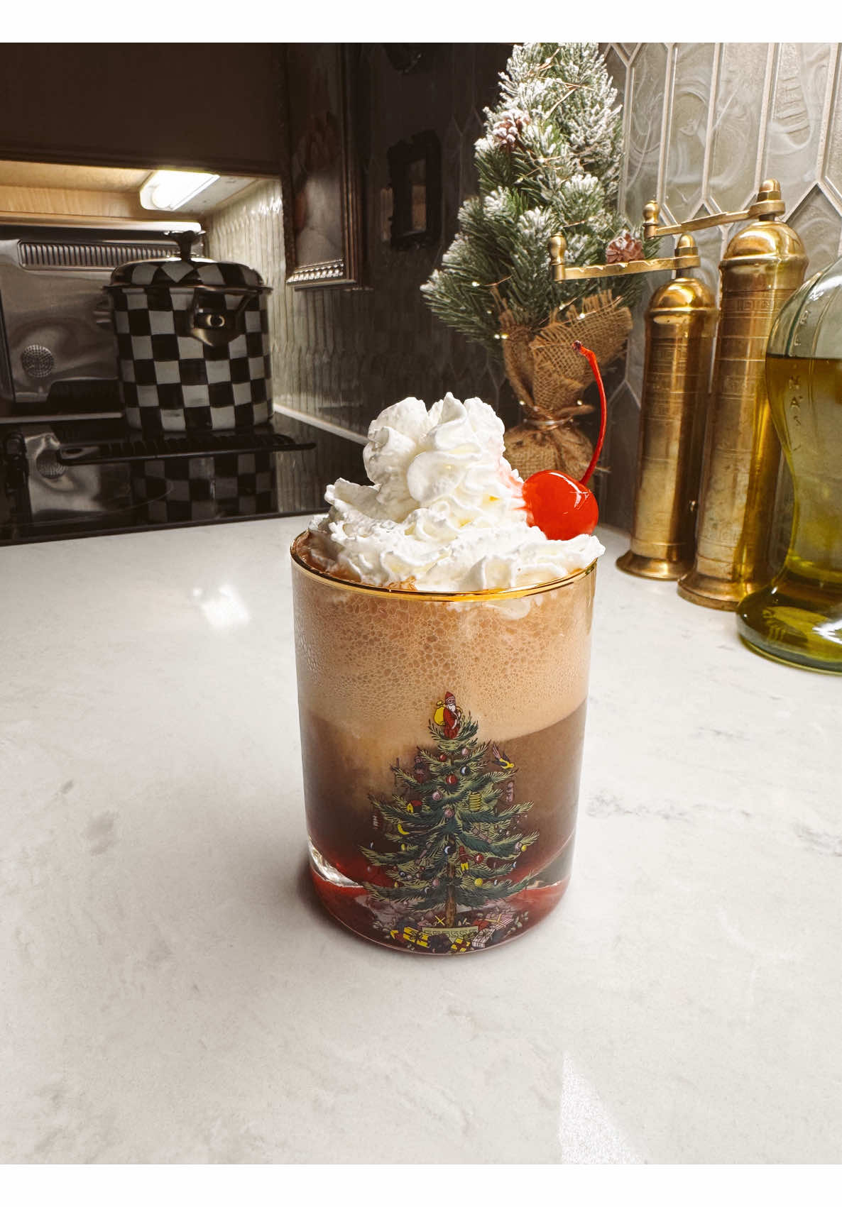 Cozy holiday christmas drink with whipped cream and cherry in festive glass