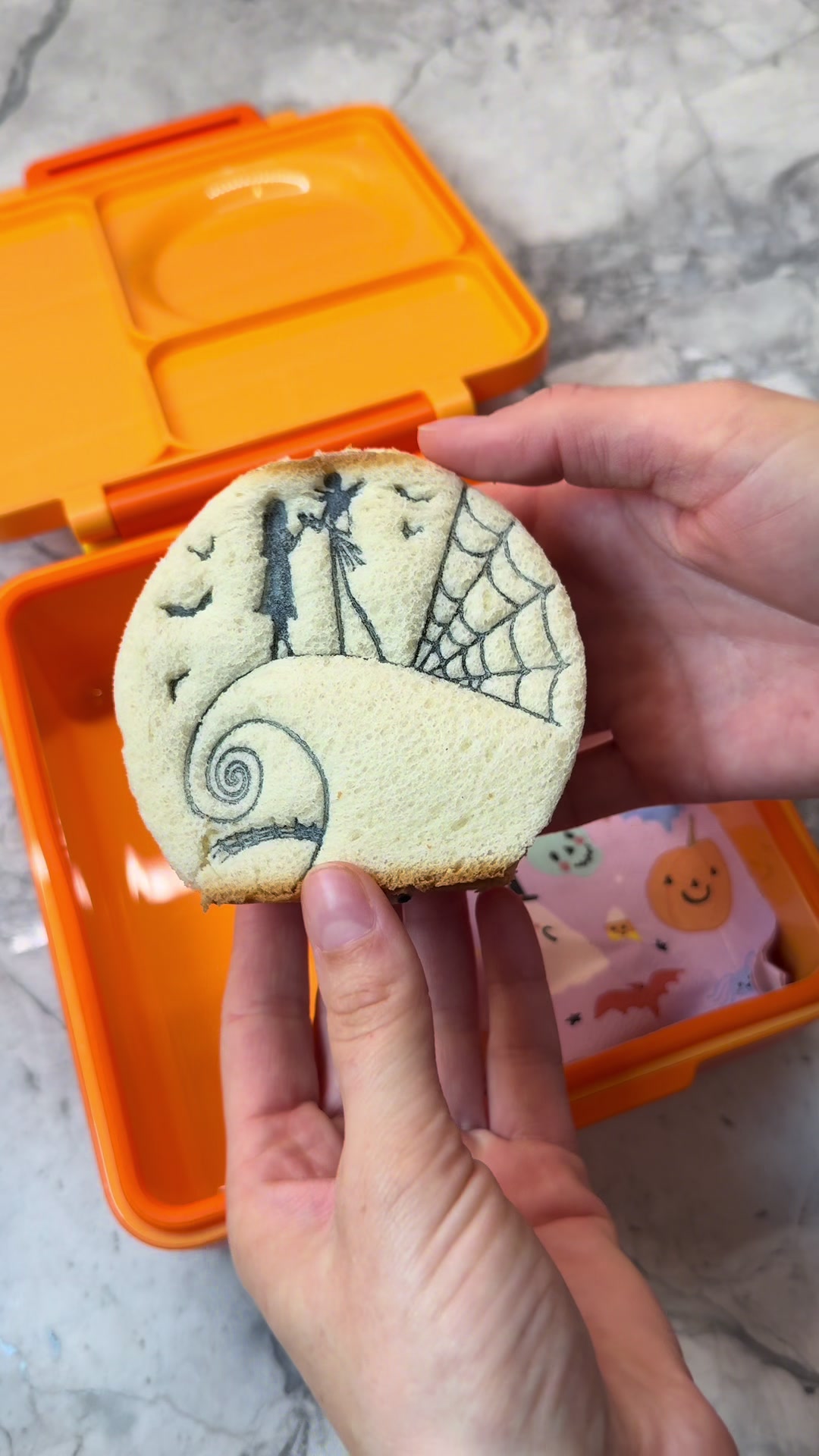 Movie-inspired sandwich art using food coloring pens on tuna filling