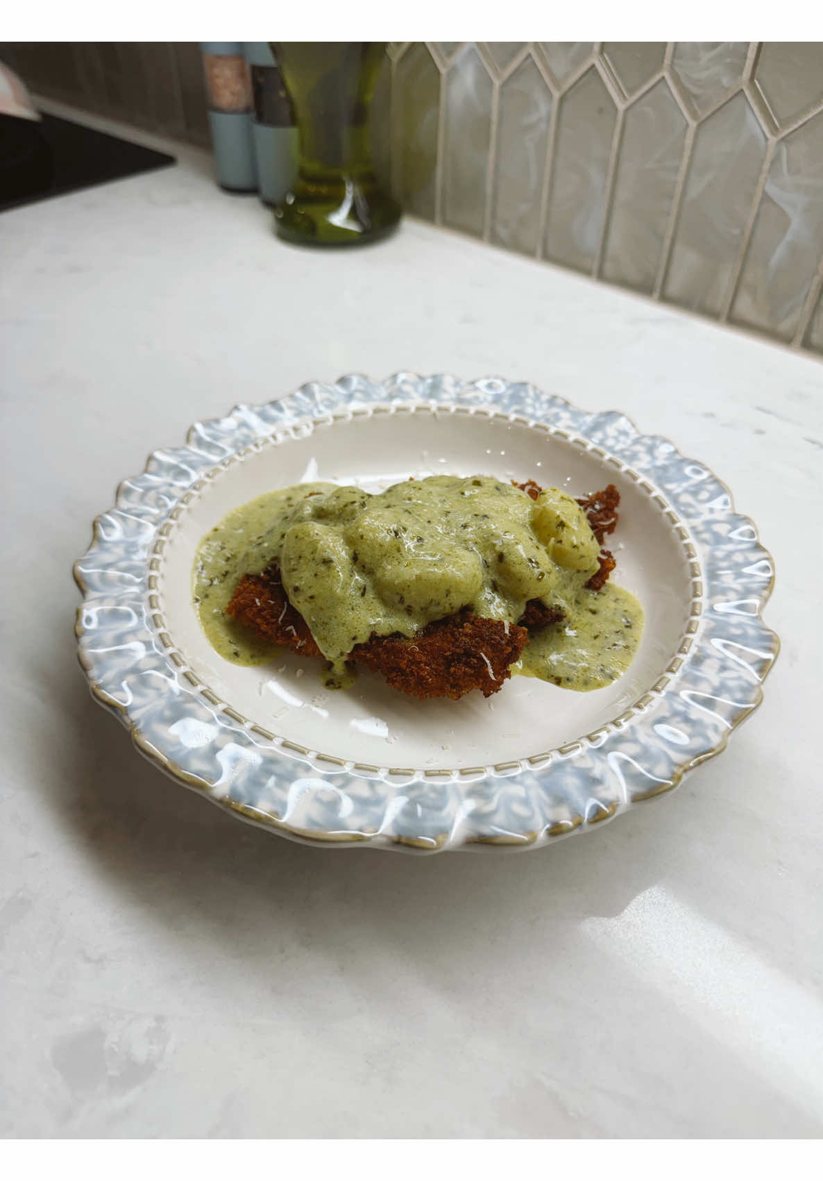 Crispy breaded cutlet with creamy green herb gnocchi sauce homemade dinner