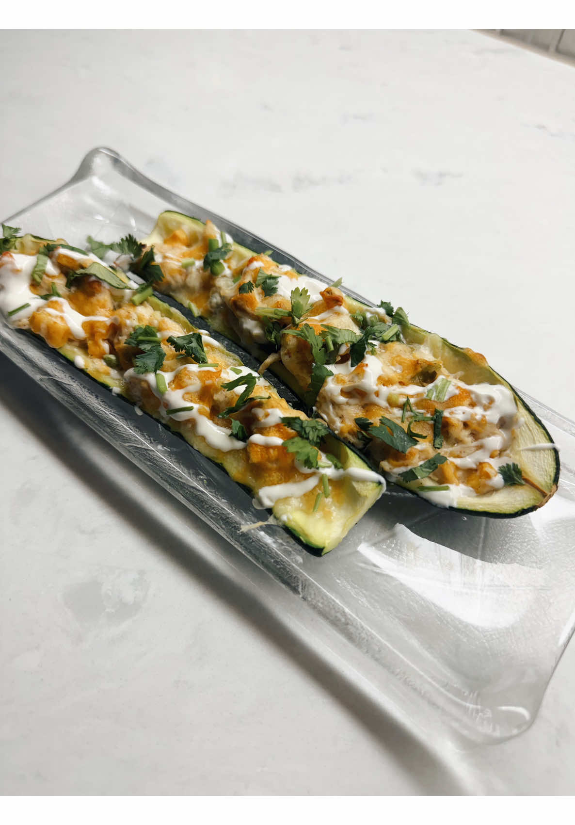 Making spicy buffalo chicken zucchini boats following voice commands
