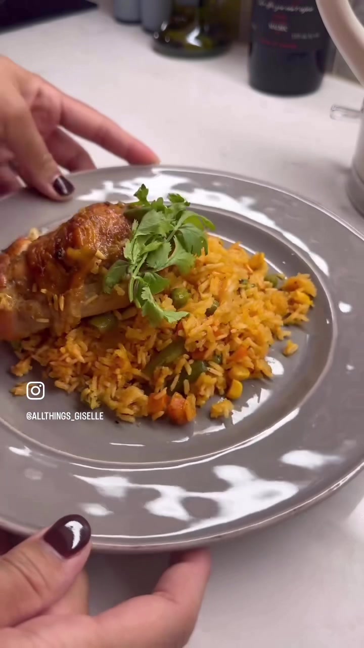 Plating delicious roasted chicken leg and veggie rice meal with cilantro garnish