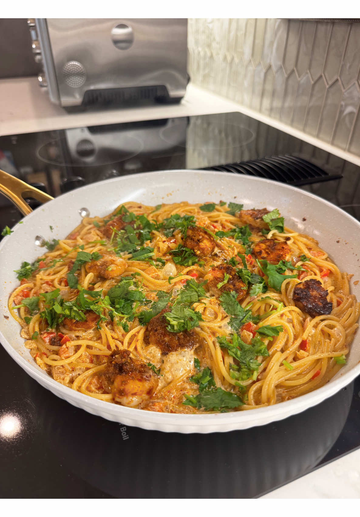 Making spicy occasion shrimp creamy spaghetti recipe with red onion bell pepper and herbs