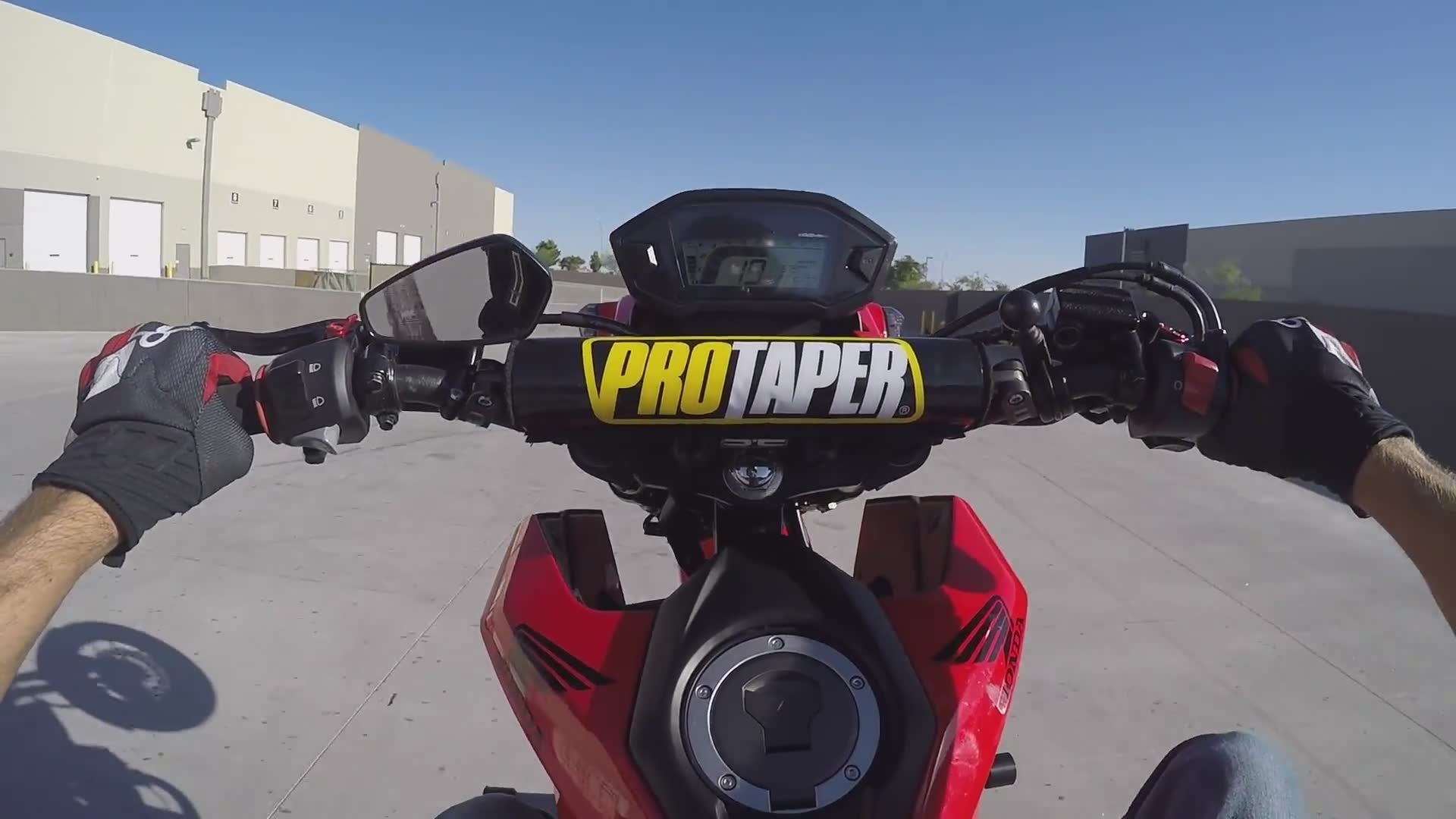 Mini bike wheelie practice session concludes with rider hitting the ground