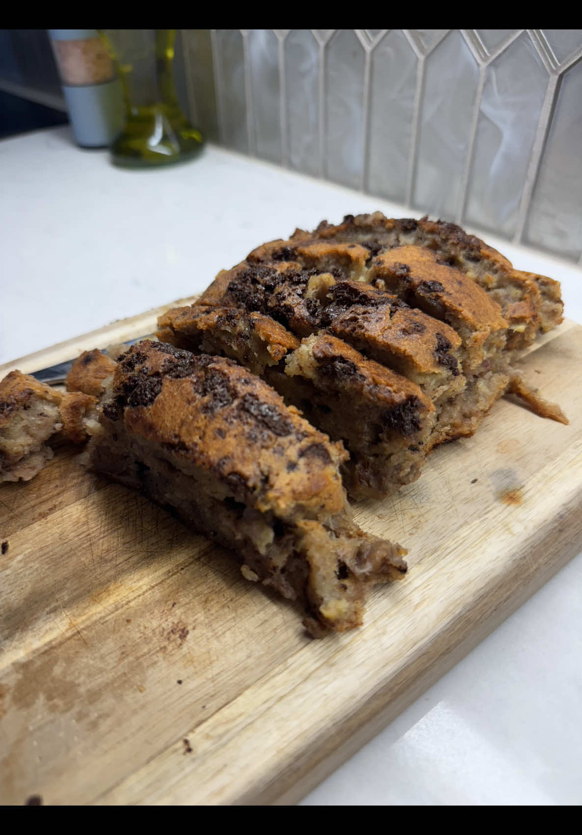 Next day vlog showing beautiful homemade sliced chocolate chip banana bread for guests in sunlight