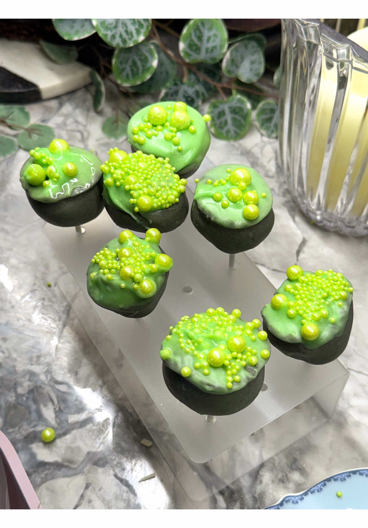 Green sparkling punch served alongside homemade cake pop desserts