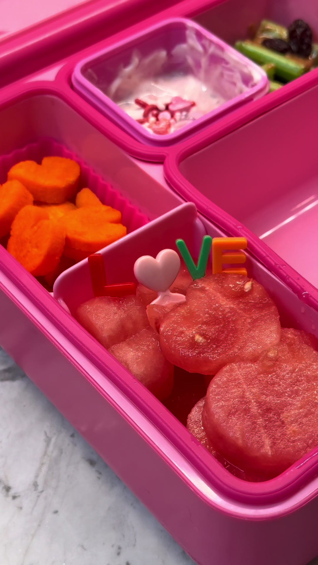 Love day bento with sweetheart dessert, sprinkled dairy, and fruit