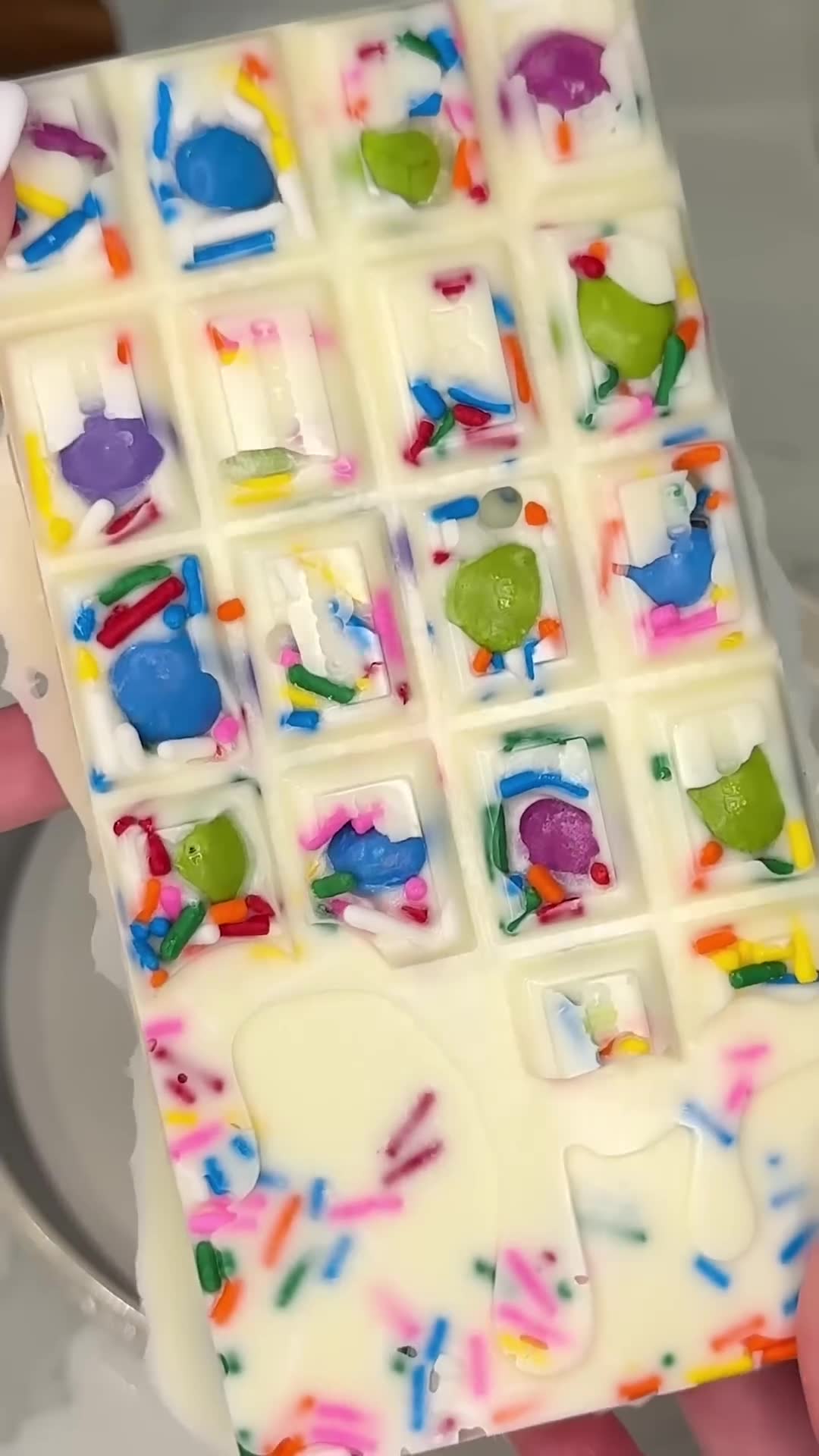 Cotton candy pieces suspended in white chocolate form nostalgic treat