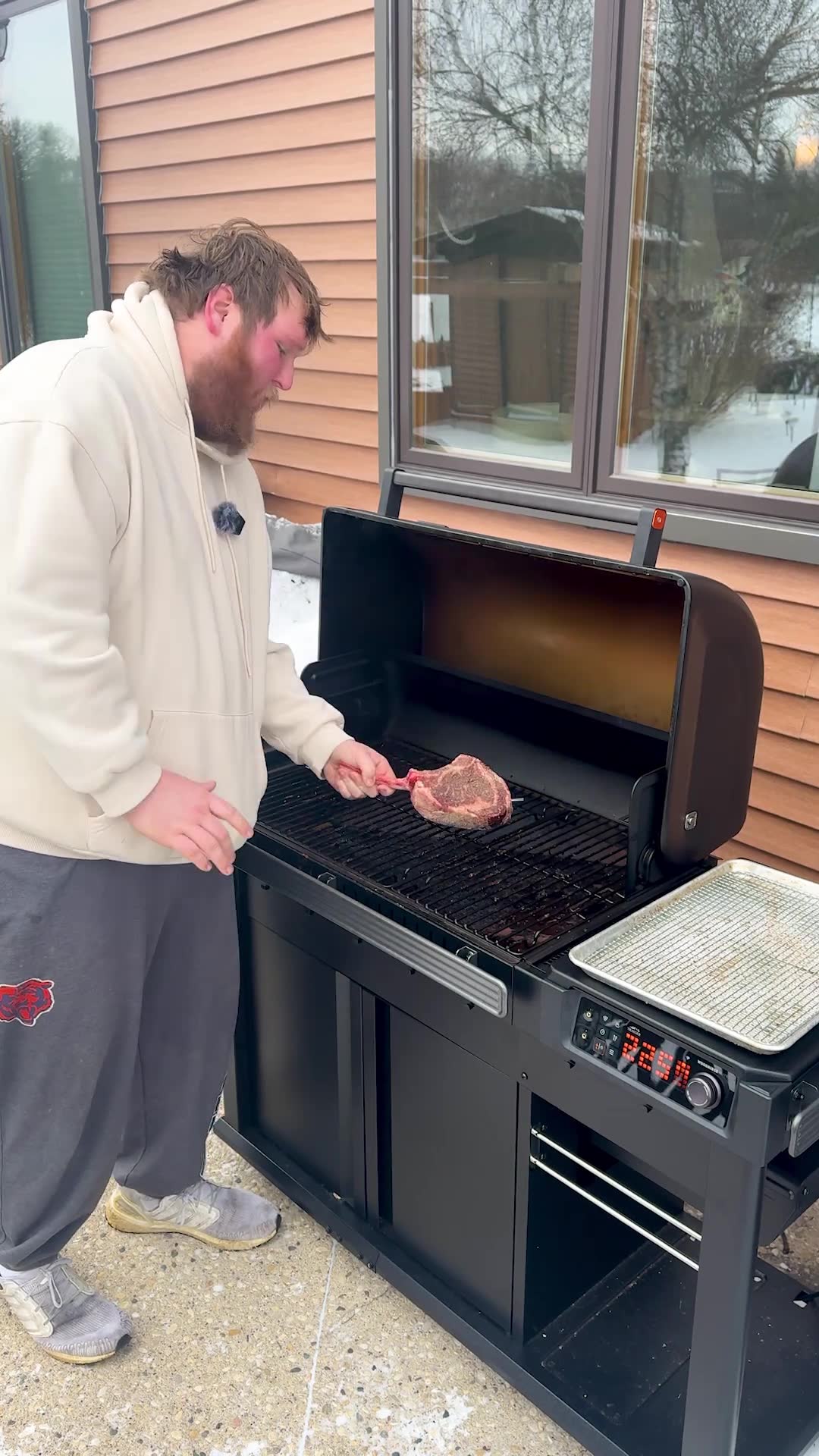 Cold weather outdoor grilling with a massive tomahawk steak on display