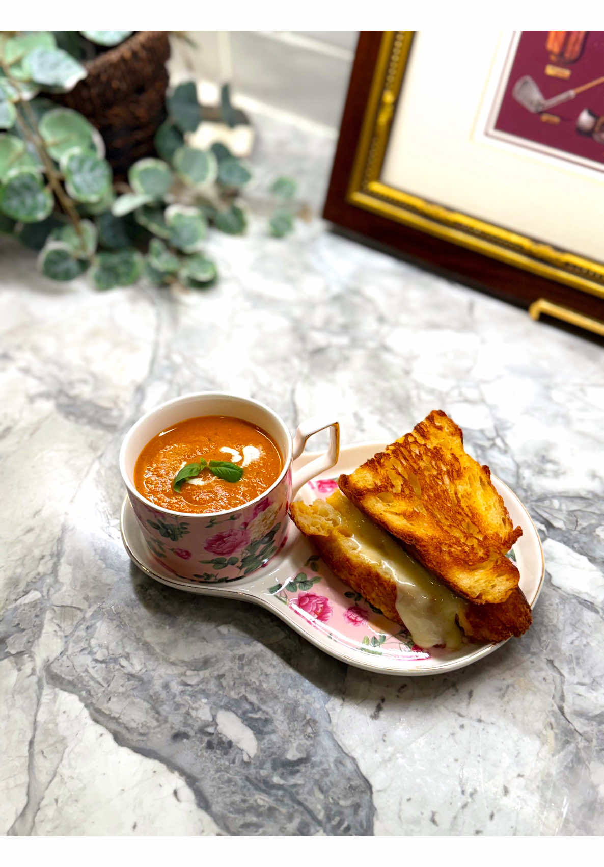 Fresh roasted tomato soup with melted cheese sandwich on the side