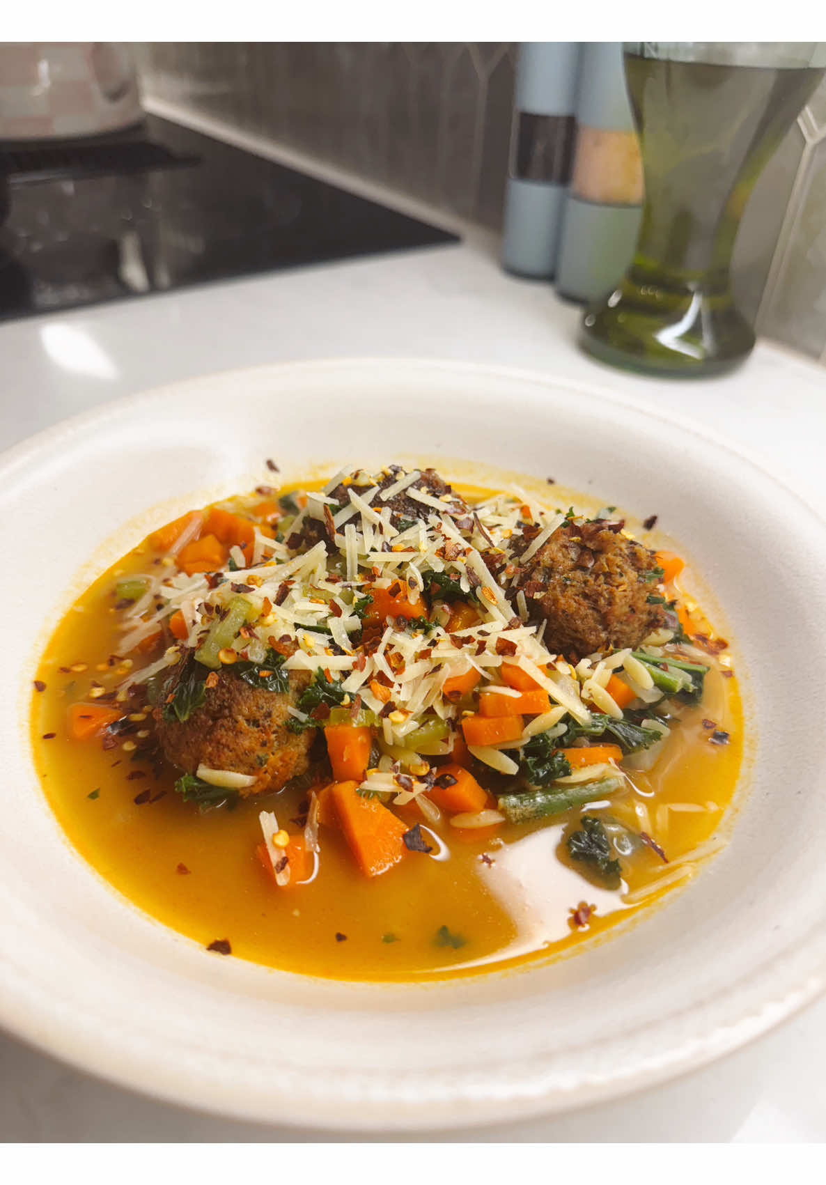 Homemade hearty meatball vegetable orzo soup recipe with cheese for sharing