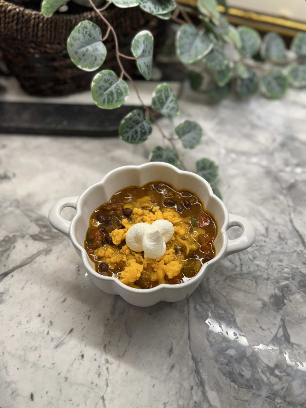 Seasonal comfort food beef chili enhanced with pumpkin and cheese