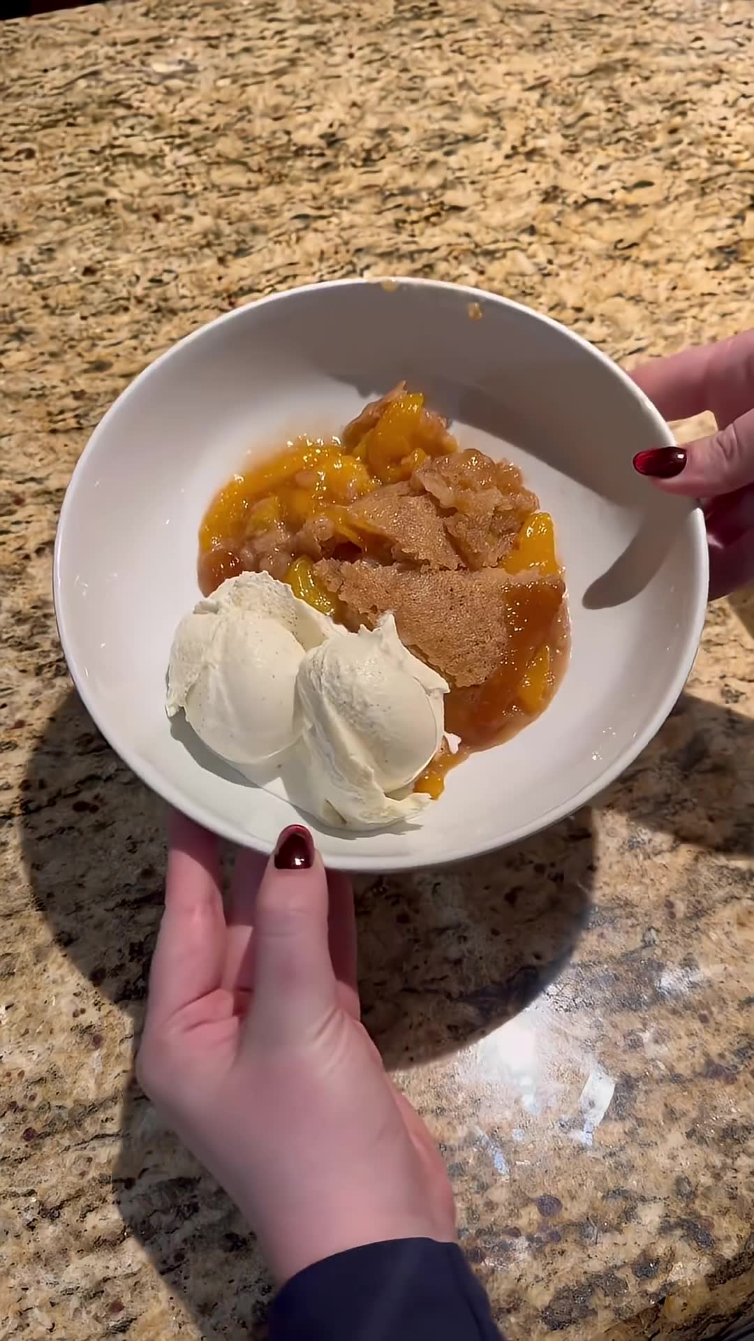 From-scratch peach cobbler paired with vanilla bean ice cream