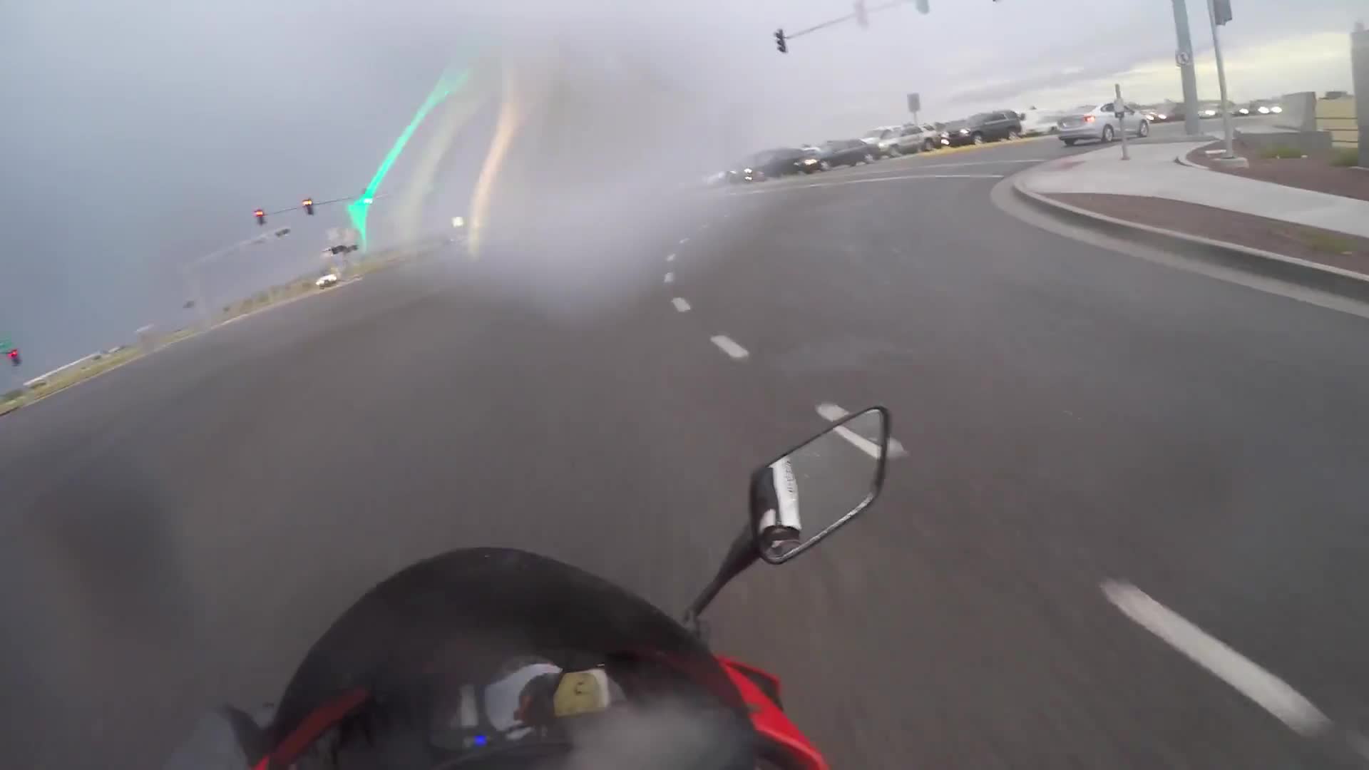 Riding in the rain filmed from motorcycle perspective on the street