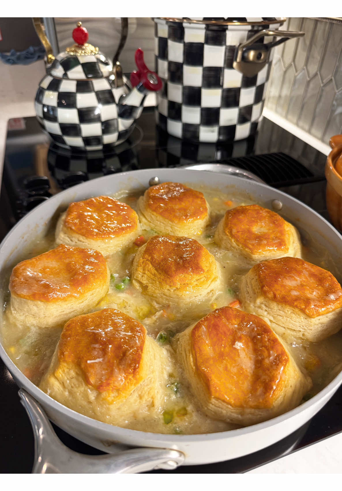 Homemade creamy chicken pot pie filling unda fluffy golden biscuits skillet
