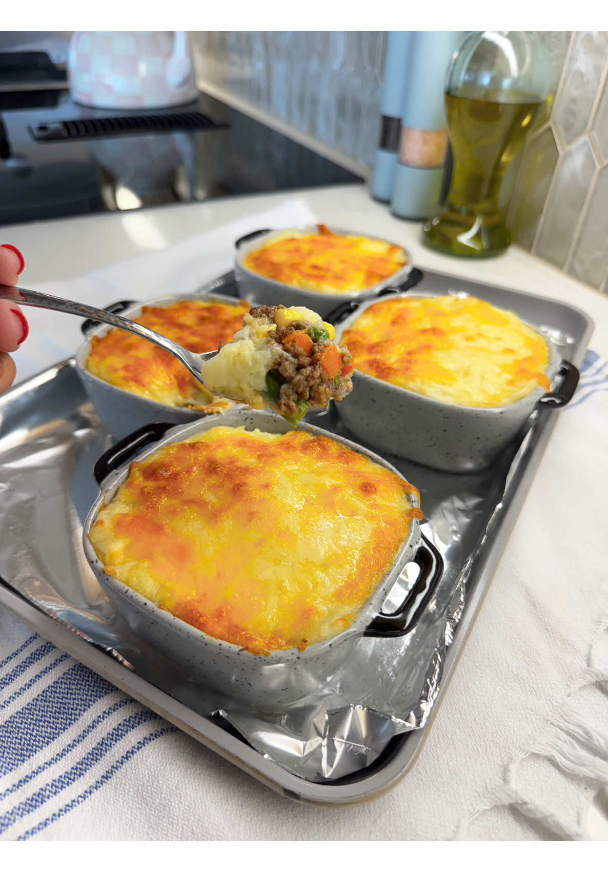 Serving homemade shepherds pie individual portions with golden mashed potato topping comfort food