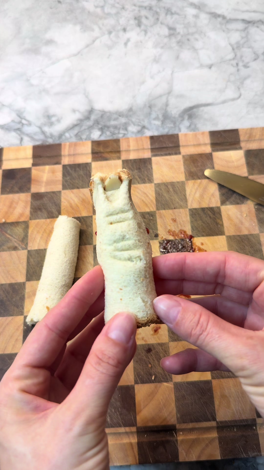 Eerie sandwich design featuring almond fingernail details