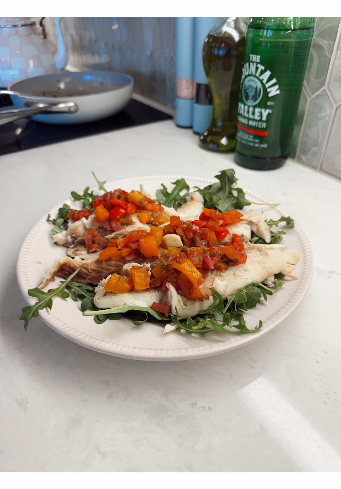 Cooking healthy white fish with pepper salsa for dinner before a walk to find toys