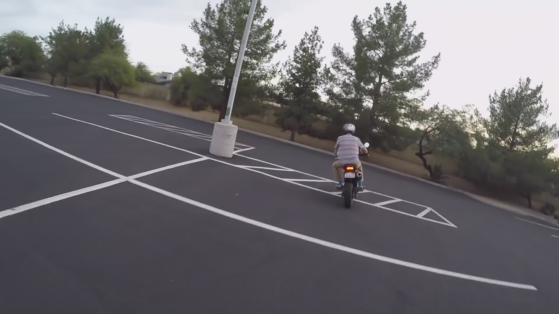 Brother loses balance and drops sport bike in parking lot