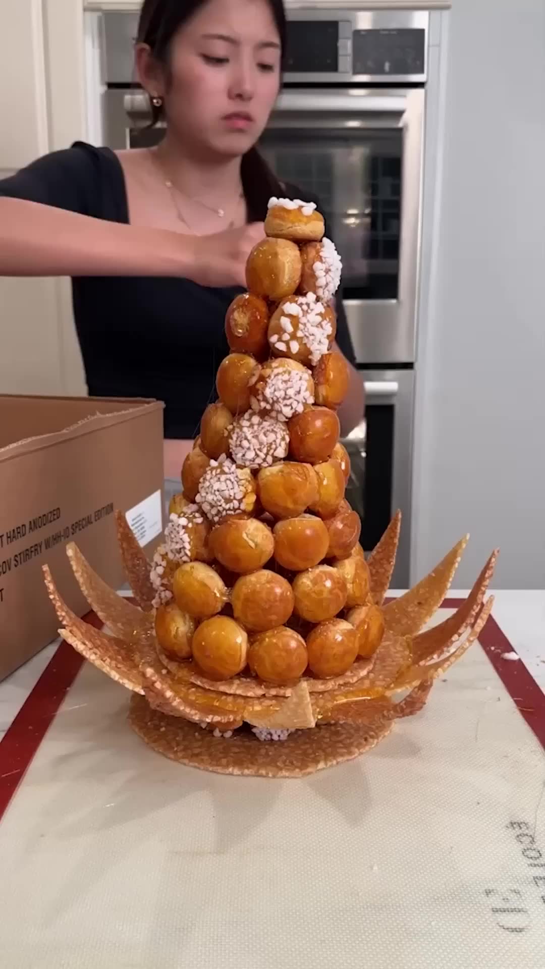 Carefully transporting a delicate croquembouche tower