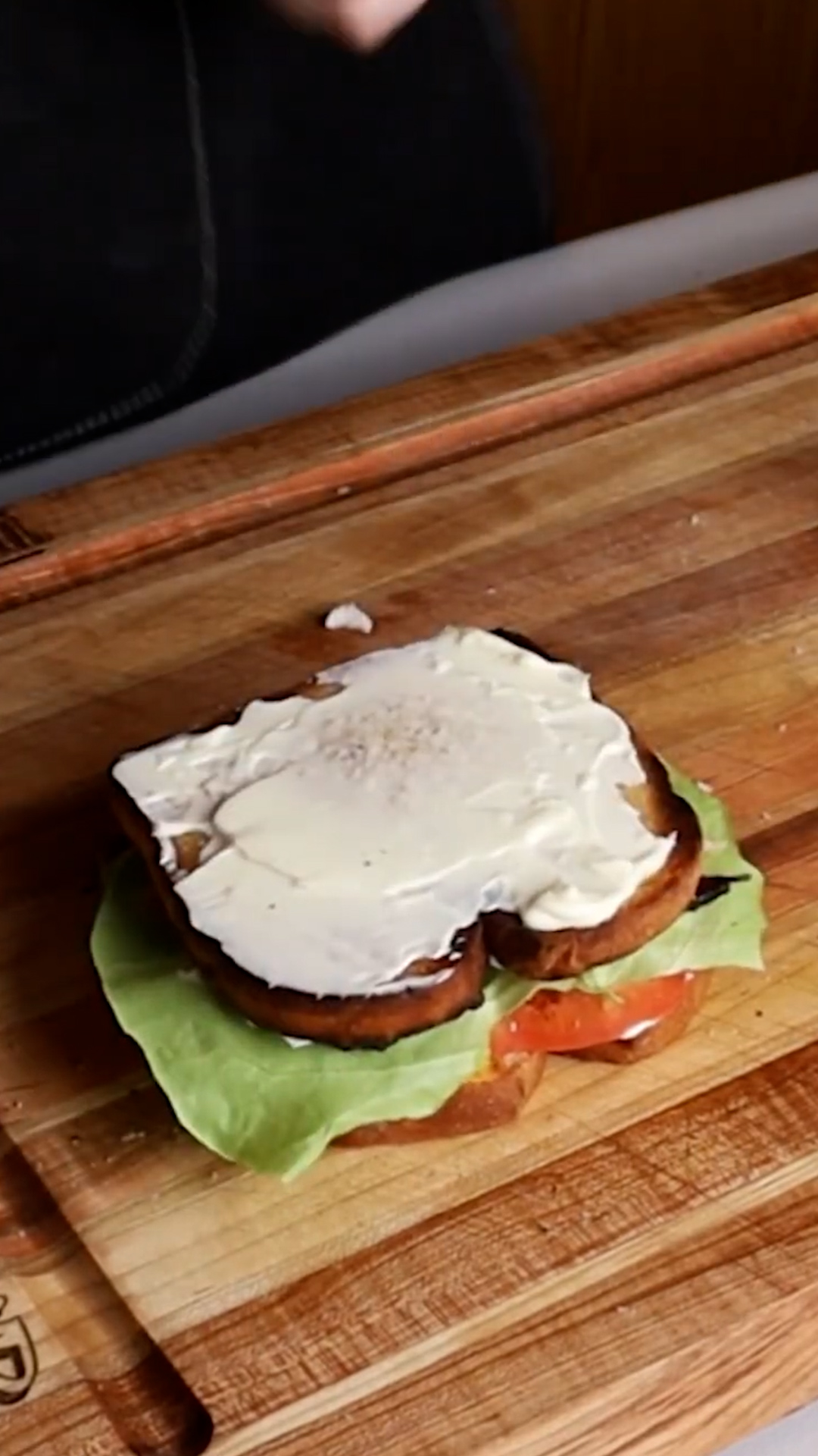 Triple-decker club sandwich with roasted chicken, bacon, and fresh tomato