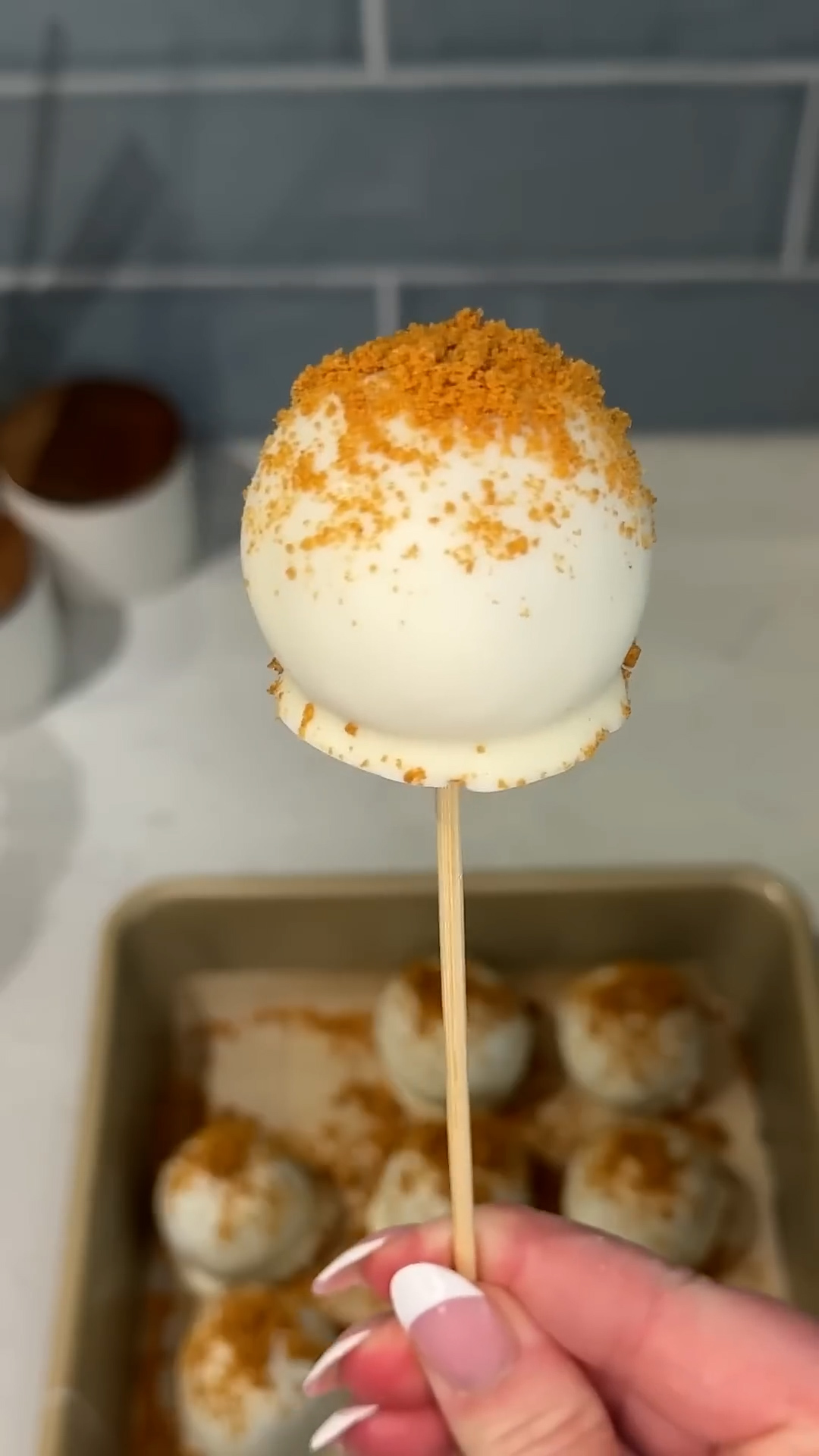 Crushed spiced cookies mixed with frosting and shaped on sticks