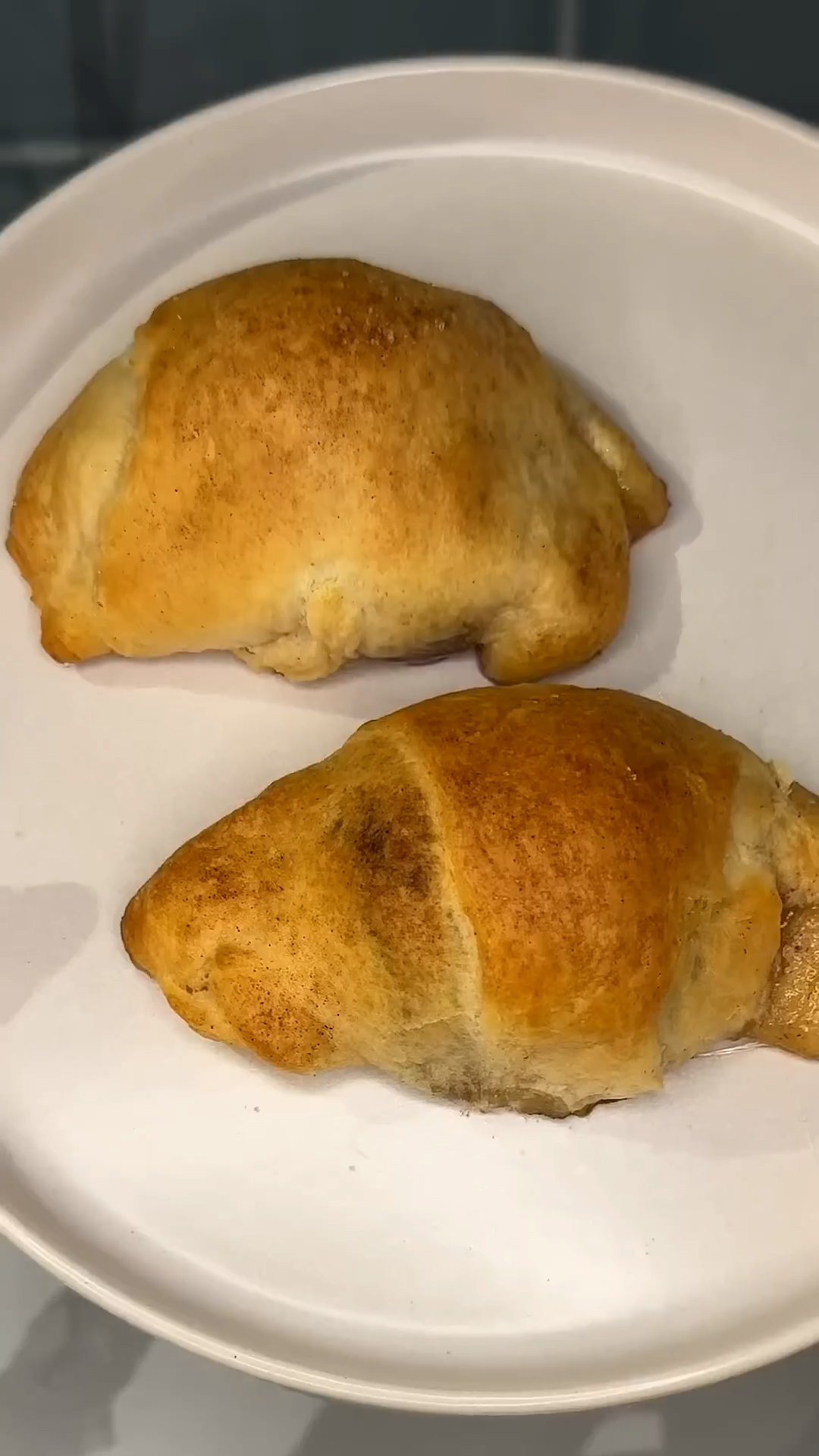 Puffy white candy wrapped in pastry dough with cinnamon coating
