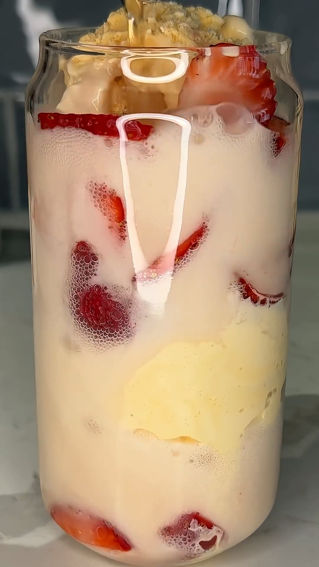 Ice cream scoops floating in strawberry-flavored soda