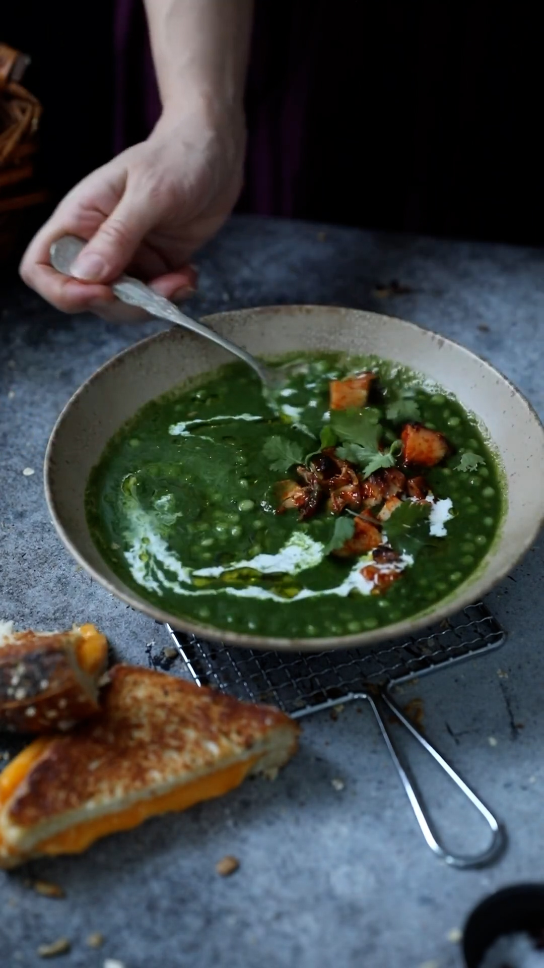 Vegetable soup served alongside hearty sandwiches